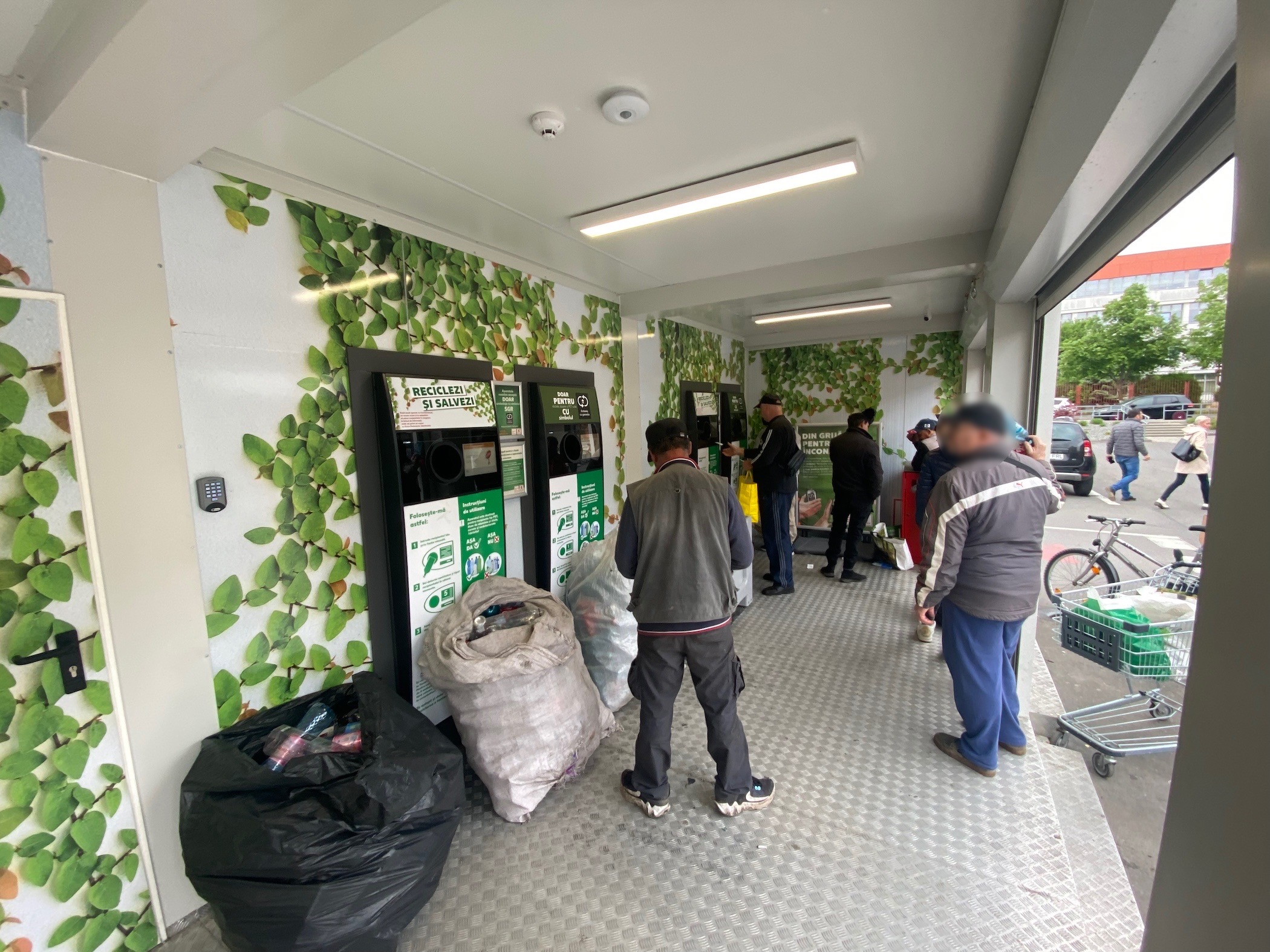 People collecting multiple bags of trash to recycle in exchange for the guarantee.