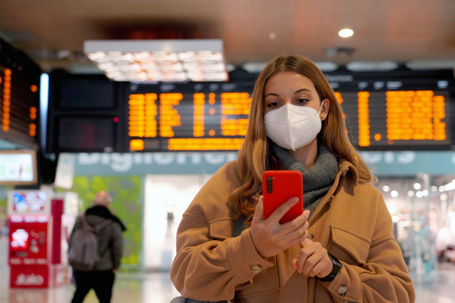 Woman in airport wearing a mask.q