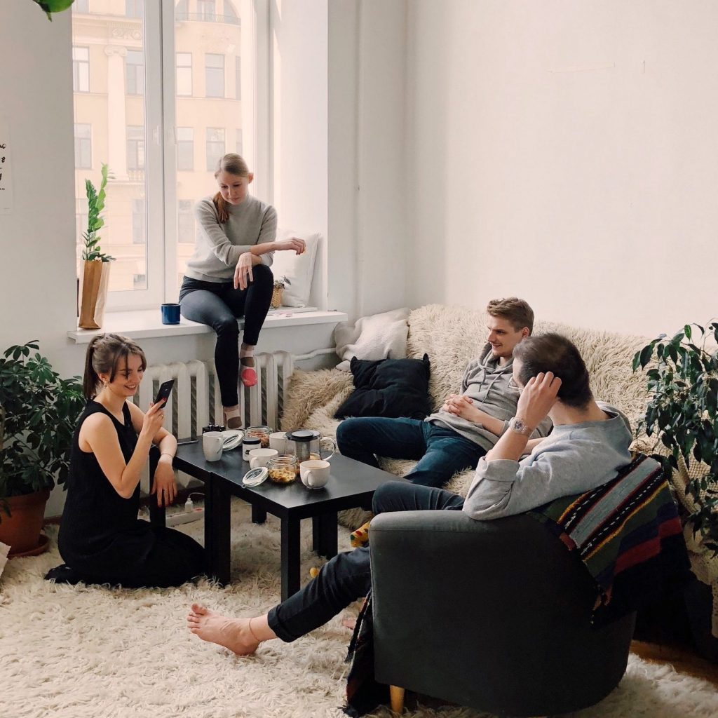 Group of people socialising in lounge.